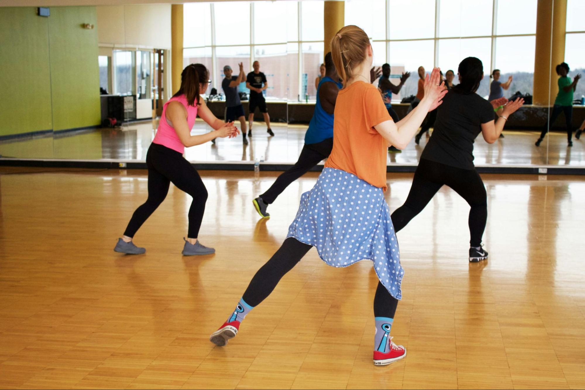 Instructor guiding students through Cumbia partner dance techniques